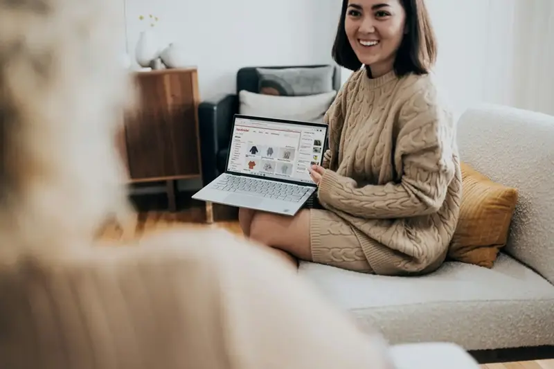 Woman shopping online with credit card and laptop